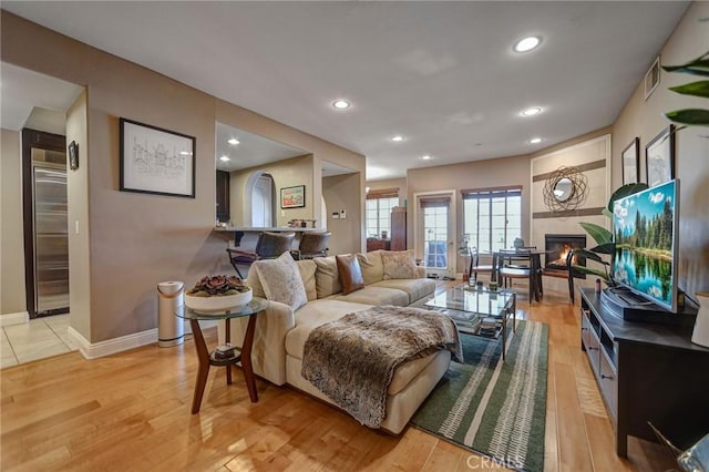 4805 Bellflower Ave Unit 205, North Hollywood, CA 91601 - living area featuring light wood finished floors, a fireplace, baseboards, visible vents, and recessed lighting