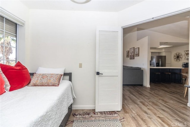 1929 Casa Linda St, Needles, CA 92363 - bedroom with baseboards, light wood finished floors, and stainless steel refrigerator with ice dispenser