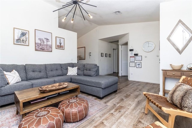 1929 Casa Linda St, Needles, CA 92363 - living area featuring a chandelier, visible vents, vaulted ceiling, and light wood-style flooring