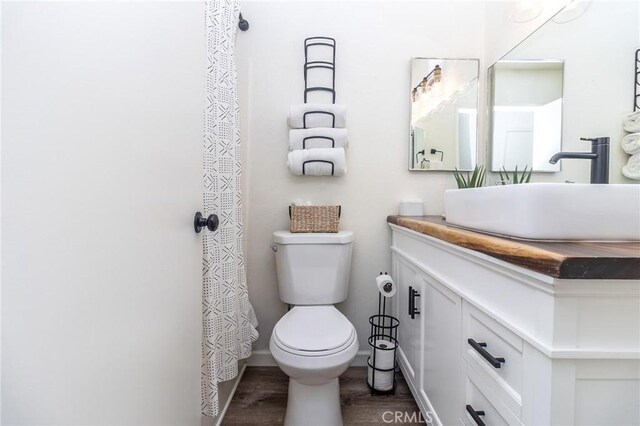 1929 Casa Linda St, Needles, CA 92363 - bathroom with toilet, wood finished floors, and vanity
