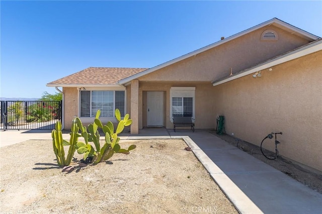 1929 Casa Linda St, Needles, CA 92363 - doorway to property featuring stucco siding and fence