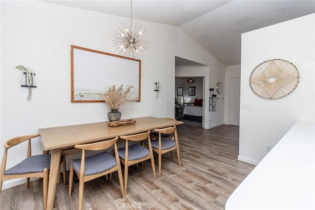 1929 Casa Linda St, Needles, CA 92363 - dining space with light wood-style floors, a notable chandelier, baseboards, and lofted ceiling