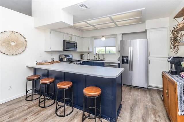 1929 Casa Linda St, Needles, CA 92363 - kitchen with a peninsula, light wood-style floors, light countertops, and stainless steel appliances