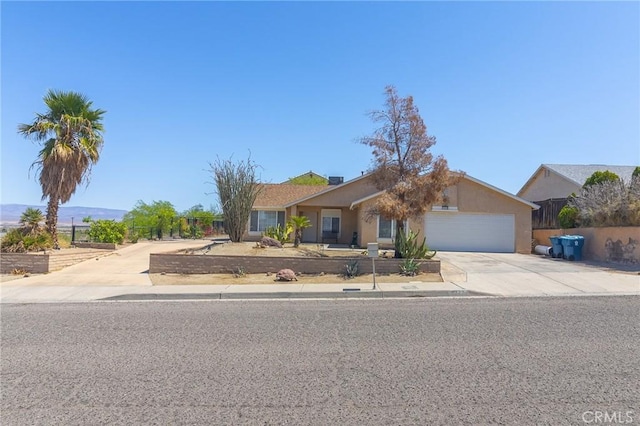 1929 Casa Linda St, Needles, CA 92363 - ranch-style house featuring concrete driveway, stucco siding, fence, and an attached garage