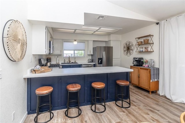 1929 Casa Linda St, Needles, CA 92363 - kitchen featuring light wood-style flooring, a peninsula, visible vents, and stainless steel appliances