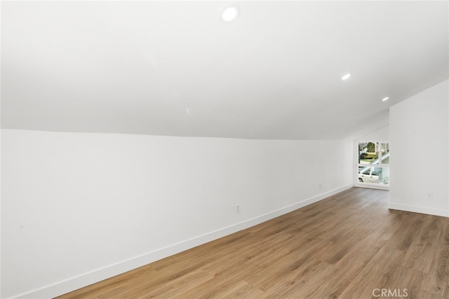 bonus room with lofted ceiling, light wood-style flooring, baseboards, and recessed lighting