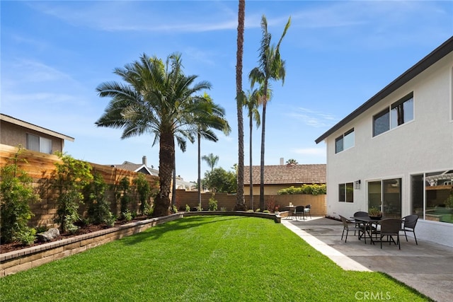 view of yard featuring a patio and a fenced backyard