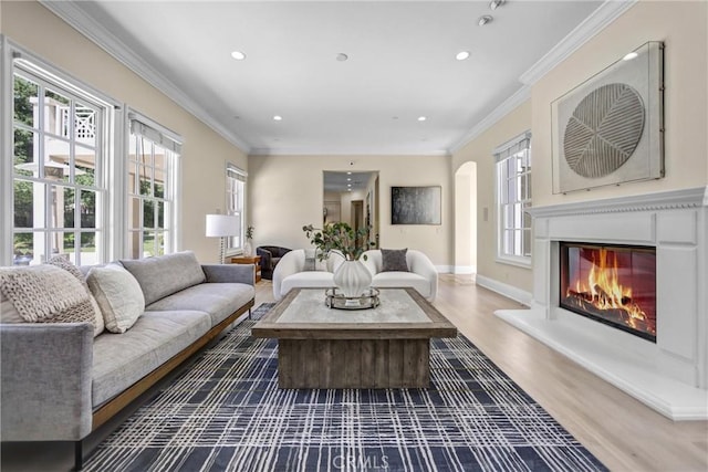 1489 Caballero Rd, Arcadia, CA 91006 - living area featuring wood finished floors, recessed lighting, a glass covered fireplace, ornamental molding, and arched walkways