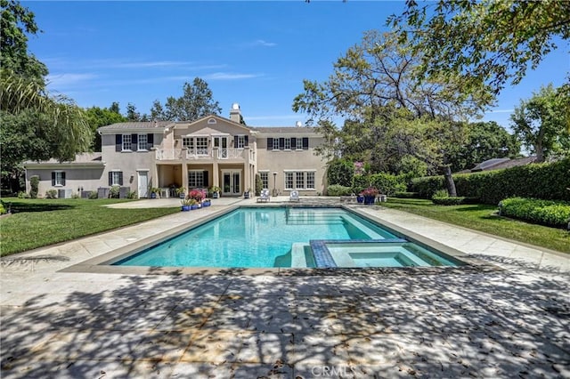 1489 Caballero Rd, Arcadia, CA 91006 - back of house featuring a balcony, a patio area, a yard, stucco siding, and a pool with connected hot tub