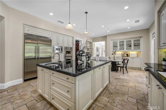 1489 Caballero Rd, Arcadia, CA 91006 - kitchen featuring built in appliances, stone tile flooring, dark countertops, and recessed lighting