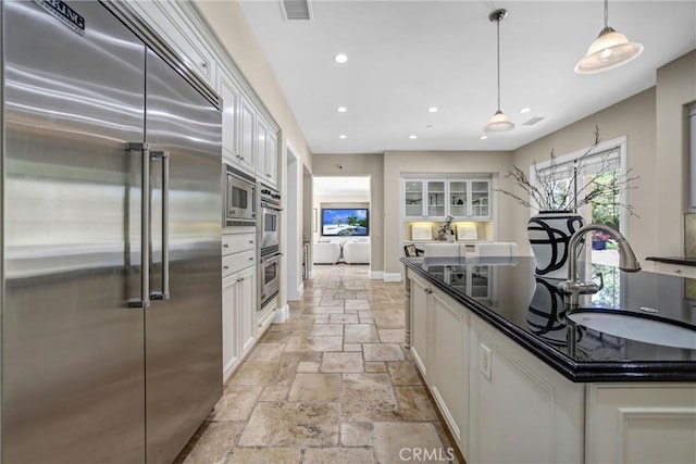 1489 Caballero Rd, Arcadia, CA 91006 - kitchen featuring built in appliances, stone tile floors, white cabinets, dark countertops, and recessed lighting