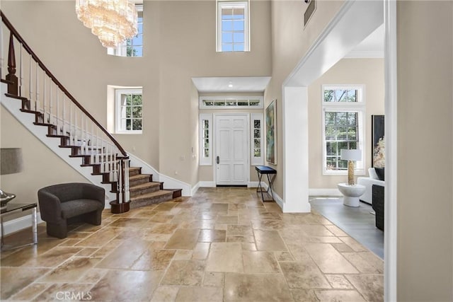 1489 Caballero Rd, Arcadia, CA 91006 - entryway featuring a high ceiling, stairs, stone tile floors, and a chandelier