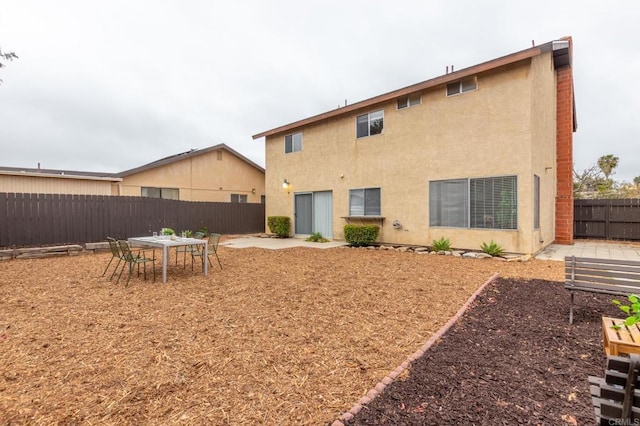 992 Churrituck Dr, San Diego, CA 92154 - back of property featuring a fenced backyard, a patio area, and stucco siding