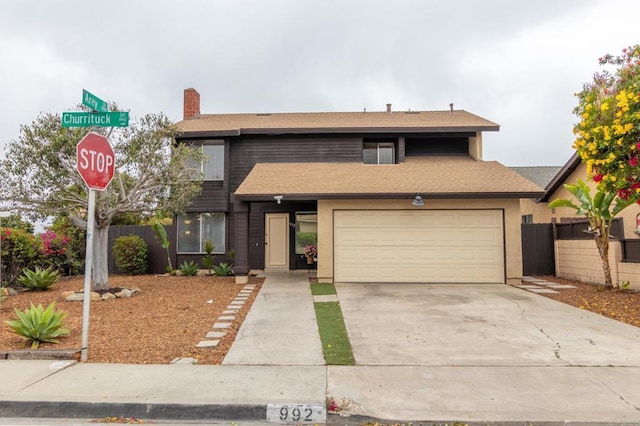 992 Churrituck Dr, San Diego, CA 92154 - view of front of home featuring a garage, fence, a chimney, and concrete driveway