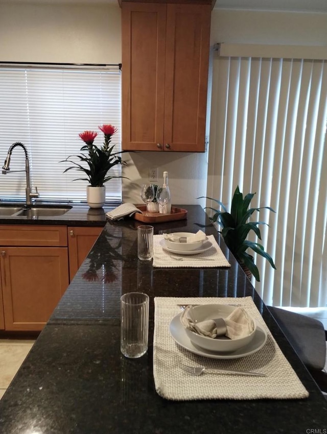 992 Churrituck Dr, San Diego, CA 92154 - kitchen featuring a sink and dark stone countertops
