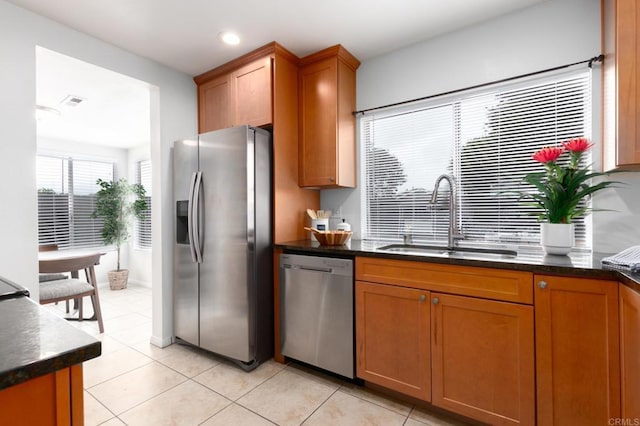992 Churrituck Dr, San Diego, CA 92154 - kitchen featuring a sink, appliances with stainless steel finishes, brown cabinetry, and dark countertops