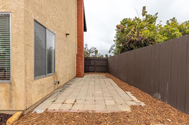 992 Churrituck Dr, San Diego, CA 92154 - view of side of property with a patio area, stucco siding, and fence