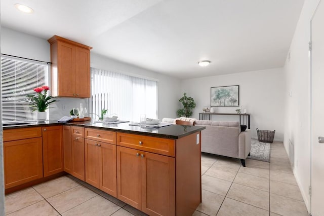 992 Churrituck Dr, San Diego, CA 92154 - kitchen featuring brown cabinets, light tile patterned flooring, open floor plan, and a peninsula