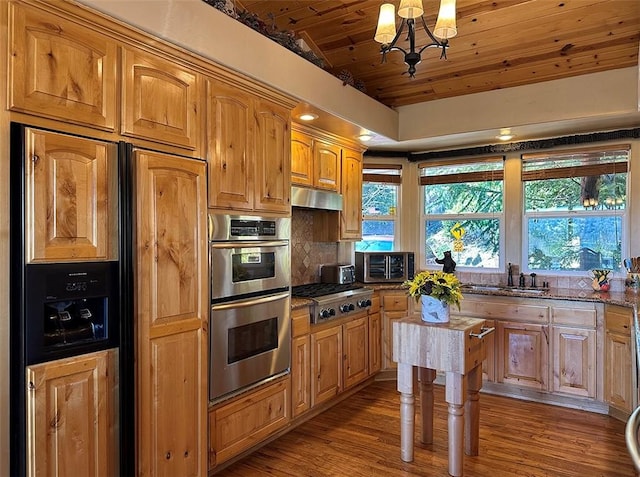 kitchen with an inviting chandelier, wooden ceiling, tasteful backsplash, dark stone countertops, and stainless steel appliances