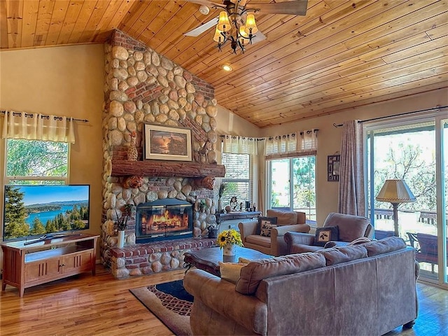 living area with plenty of natural light, a ceiling fan, lofted ceiling, and wooden ceiling