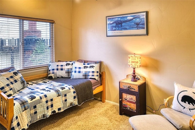 carpeted bedroom featuring baseboards