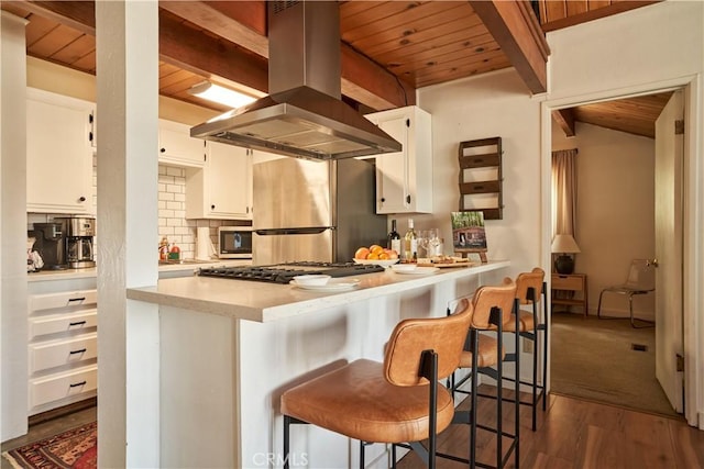 kitchen with wood ceiling, island exhaust hood, dark wood finished floors, white cabinets, and beamed ceiling