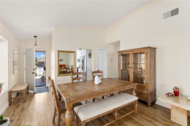 27263 Family Cir, Menifee, CA 92586 - dining area featuring light wood-style floors, high vaulted ceiling, baseboards, and visible vents