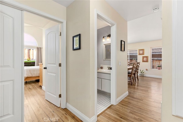 27263 Family Cir, Menifee, CA 92586 - hallway featuring light wood finished floors, baseboards, and a sink