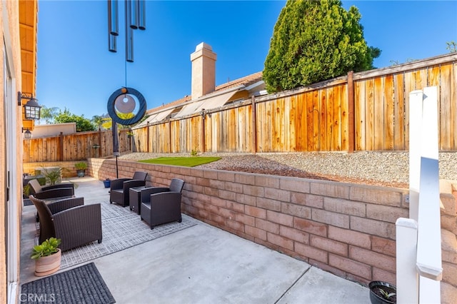 27263 Family Cir, Menifee, CA 92586 - view of patio featuring a fenced backyard and an outdoor living space