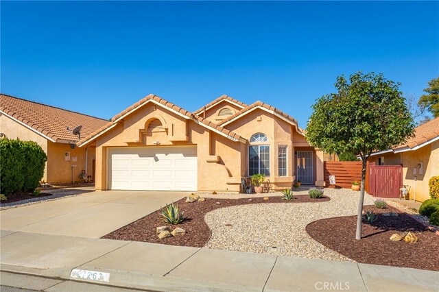 27263 Family Cir, Menifee, CA 92586 - mediterranean / spanish home with an attached garage, stucco siding, fence, and a tile roof