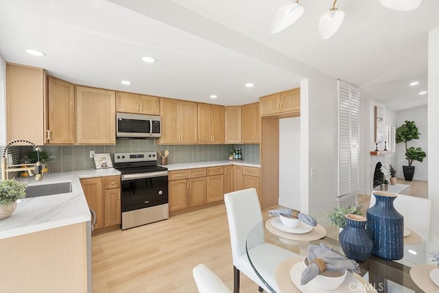28116 Calle Casal, Mission Viejo, CA 92692 - kitchen featuring tasteful backsplash, recessed lighting, appliances with stainless steel finishes, light wood finished floors, and a sink