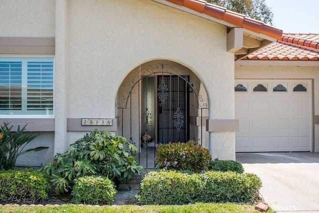 28116 Calle Casal, Mission Viejo, CA 92692 - entrance to property with a garage, driveway, stucco siding, and a tile roof