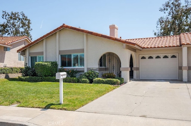 28116 Calle Casal, Mission Viejo, CA 92692 - mediterranean / spanish house with a front yard, an attached garage, a tile roof, stucco siding, and driveway
