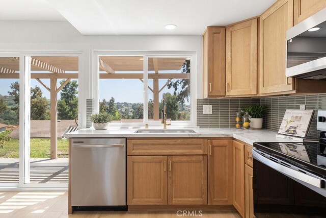 28116 Calle Casal, Mission Viejo, CA 92692 - kitchen featuring recessed lighting, light countertops, backsplash, stainless steel appliances, and a sink