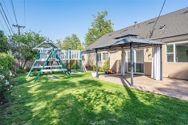 view of playground with a lawn, a gazebo, and a patio area