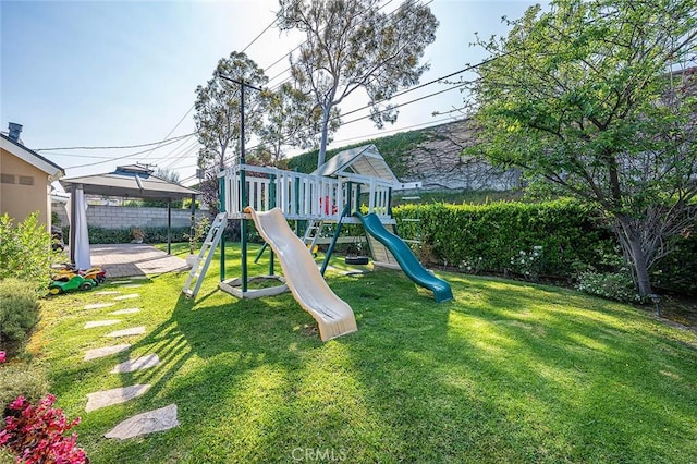 view of playground featuring a gazebo, fence, and a yard