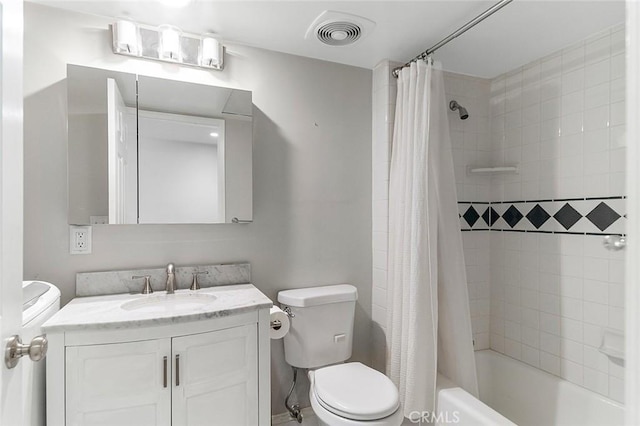 bathroom with vanity, shower / bath combo, toilet, and visible vents