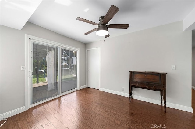 unfurnished living room with a ceiling fan, baseboards, and wood finished floors