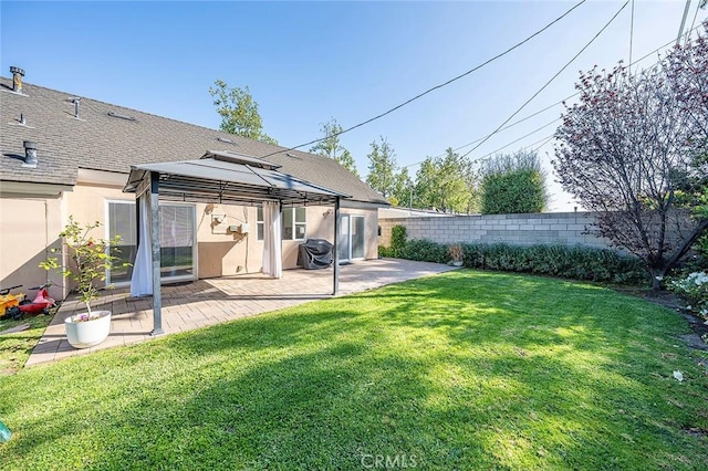back of house with a lawn, a gazebo, a fenced backyard, a patio, and stucco siding