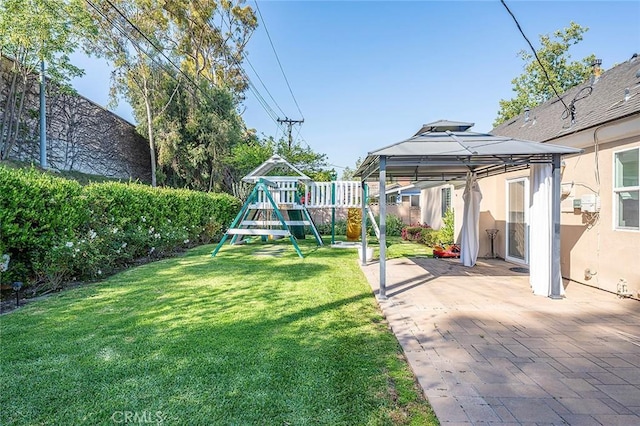 view of yard featuring a fenced backyard, a gazebo, a patio area, and a playground