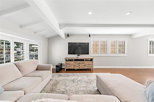 living area with recessed lighting, baseboards, lofted ceiling with beams, and wood finished floors