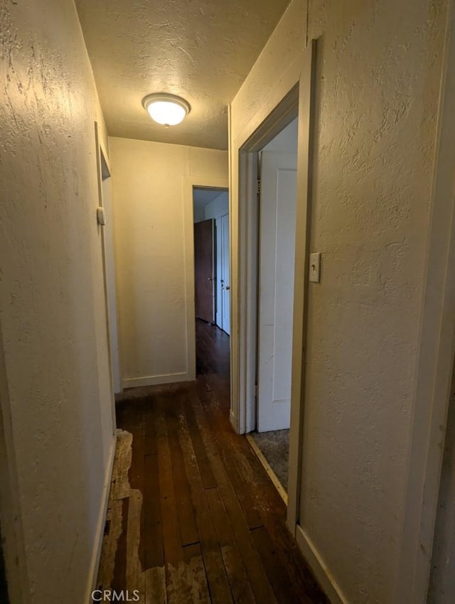 548 S Plumas St, Willows, CA 95988 - hall with a textured ceiling, a textured wall, wood-type flooring, and baseboards