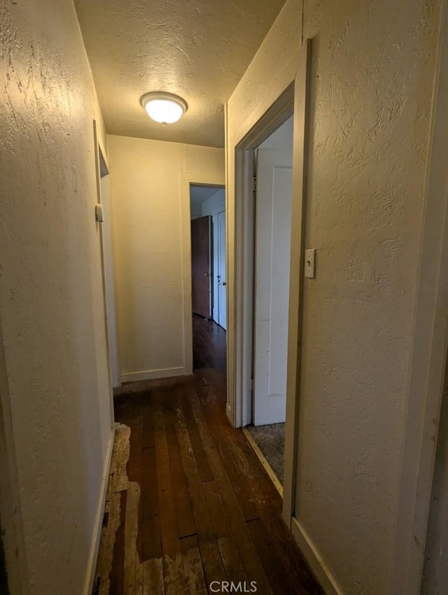 548 S Plumas St, Willows, CA 95988 - hallway with hardwood / wood-style flooring, a textured ceiling, and a textured wall