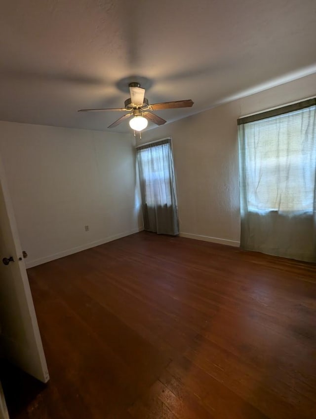 548 S Plumas St, Willows, CA 95988 - empty room featuring dark wood-style flooring, ceiling fan, and baseboards