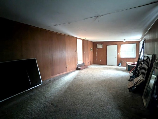 548 S Plumas St, Willows, CA 95988 - unfurnished living room featuring wood walls, baseboards, and carpet flooring