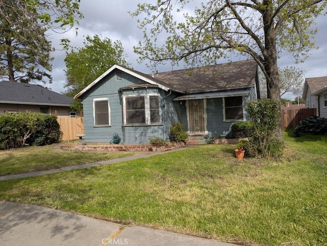 548 S Plumas St, Willows, CA 95988 - view of front facade with roof with shingles, a front yard, and fence