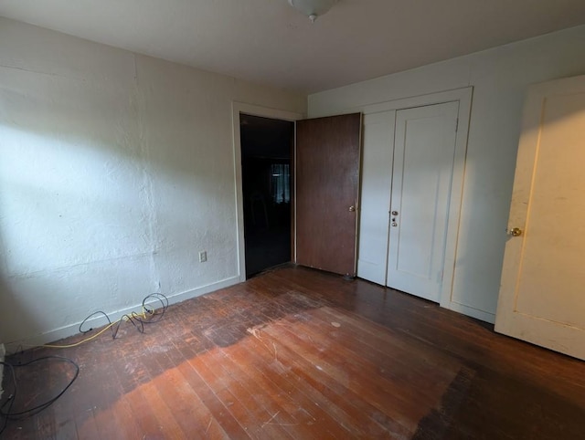 548 S Plumas St, Willows, CA 95988 - unfurnished bedroom featuring a closet, baseboards, and hardwood / wood-style floors