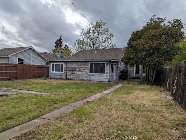 548 S Plumas St, Willows, CA 95988 - rear view of house with a fenced backyard and stone siding