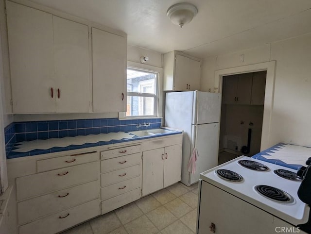 548 S Plumas St, Willows, CA 95988 - kitchen featuring a sink, tile countertops, white cabinetry, and white appliances