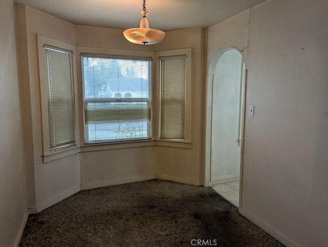 548 S Plumas St, Willows, CA 95988 - unfurnished dining area featuring carpet floors and arched walkways